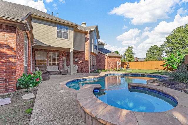 view of swimming pool featuring a patio and an in ground hot tub