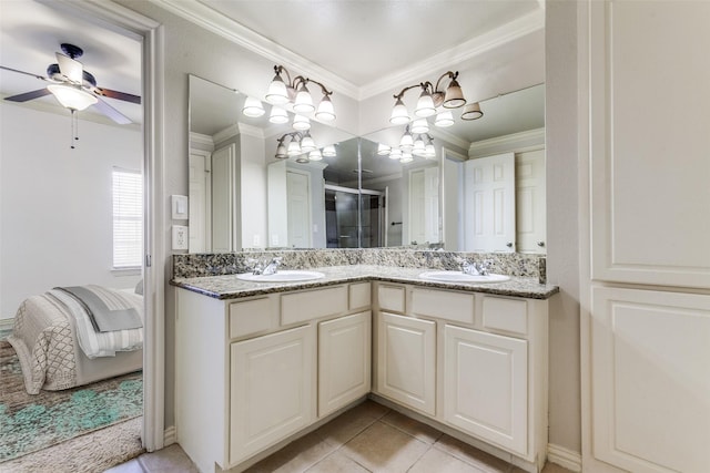 bathroom featuring tile patterned flooring, ornamental molding, ceiling fan with notable chandelier, and vanity