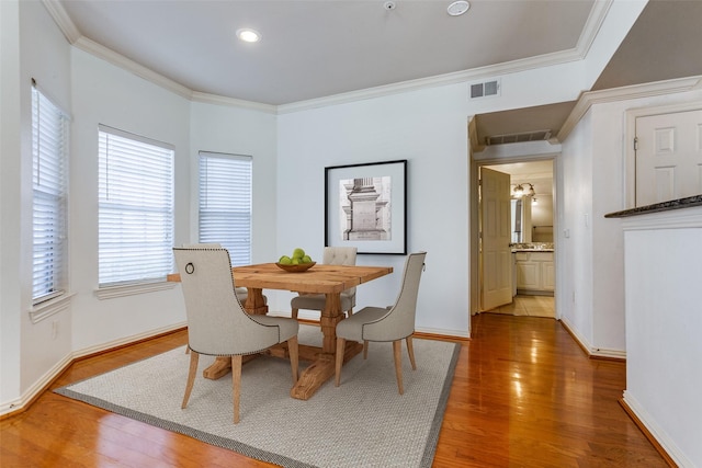 dining room featuring ornamental molding, dark wood-type flooring, and ceiling fan