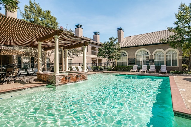 view of swimming pool featuring a pergola, a patio area, and pool water feature