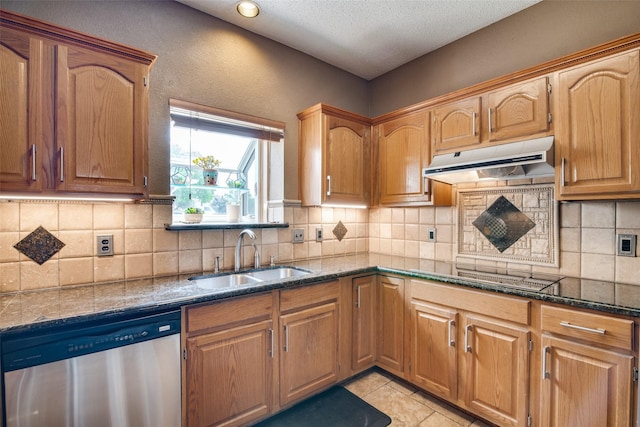 kitchen featuring dishwasher, dark stone countertops, black electric stovetop, light tile patterned floors, and sink