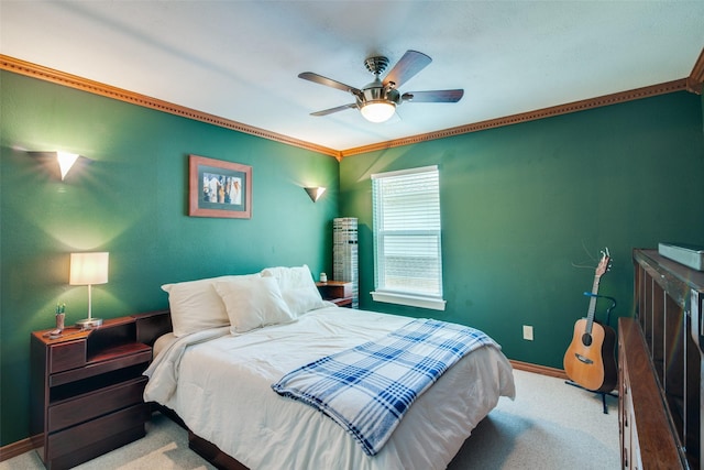 carpeted bedroom with ornamental molding and ceiling fan