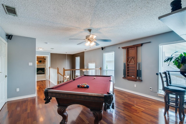 playroom featuring dark hardwood / wood-style flooring, billiards, ceiling fan, and a healthy amount of sunlight