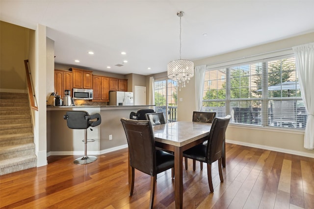 dining room featuring hardwood / wood-style floors and a notable chandelier