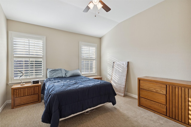 carpeted bedroom with ceiling fan and vaulted ceiling