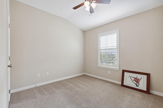 unfurnished room featuring ceiling fan, vaulted ceiling, and light carpet