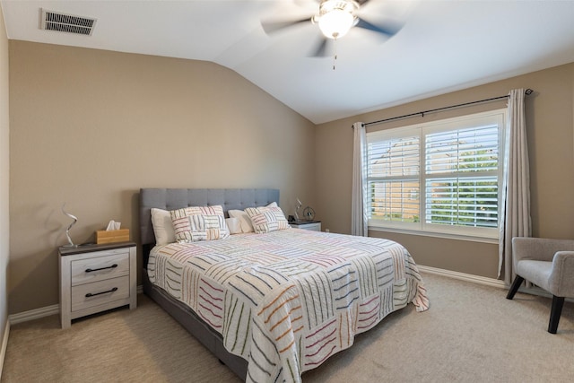 bedroom with vaulted ceiling, ceiling fan, and light carpet