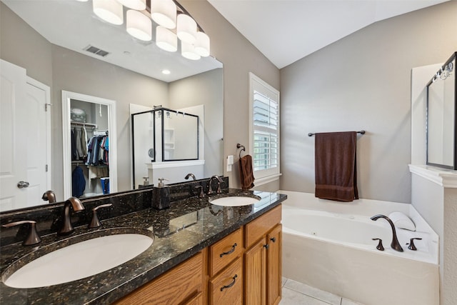 bathroom featuring lofted ceiling, tile patterned floors, separate shower and tub, and vanity