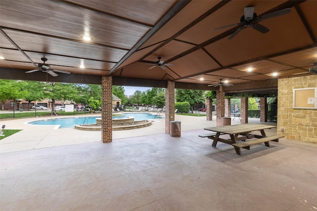 view of swimming pool featuring a patio area and ceiling fan