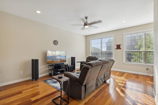 living room with ceiling fan and light wood-type flooring