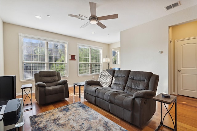 living room with ceiling fan and hardwood / wood-style flooring