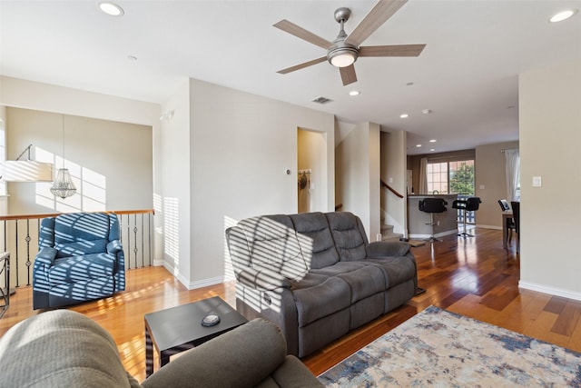 living room with ceiling fan and wood-type flooring