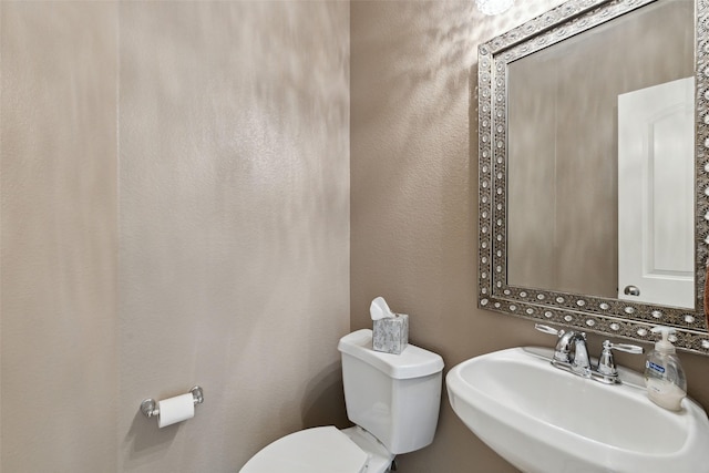 bathroom with sink and toilet