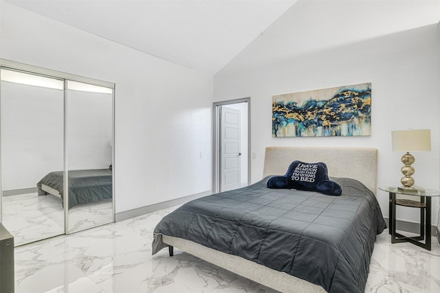 bedroom with vaulted ceiling and a closet