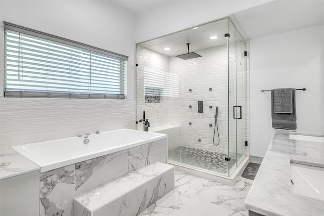 bathroom featuring independent shower and bath and sink