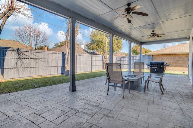 view of patio featuring a grill, ceiling fan, and an outdoor fire pit