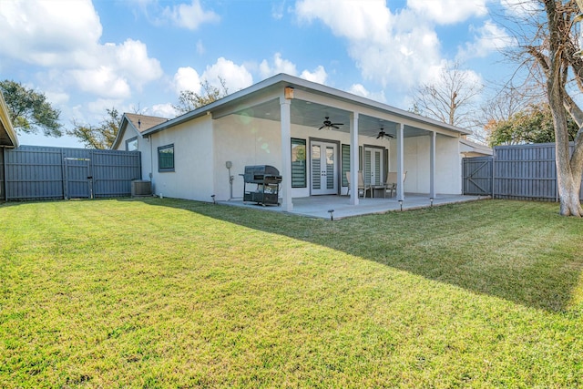 back of house featuring a patio, cooling unit, ceiling fan, and a lawn