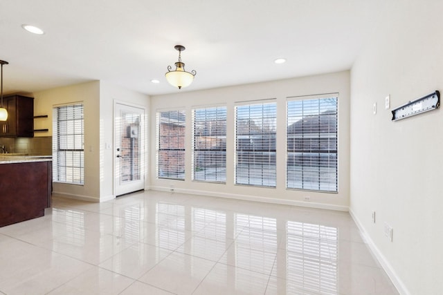 unfurnished dining area featuring light tile patterned flooring