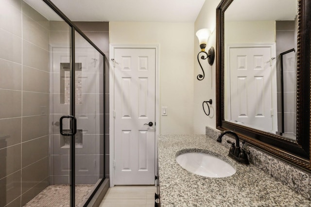 bathroom with vanity, tile patterned floors, and a shower with shower door