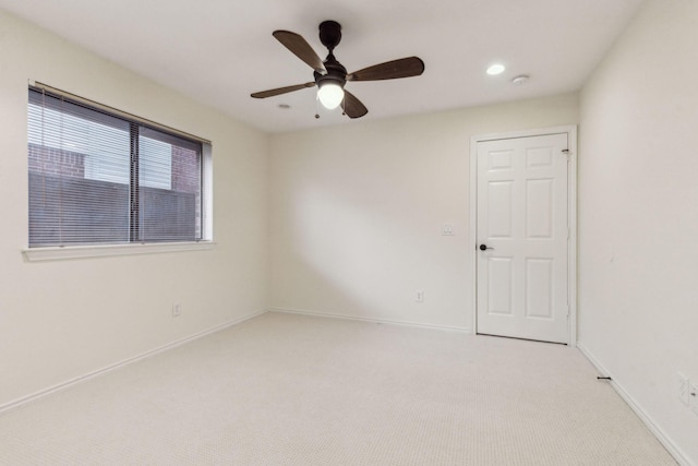 carpeted empty room featuring ceiling fan