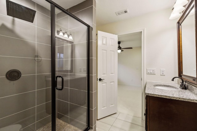 bathroom featuring ceiling fan, tile patterned floors, walk in shower, and vanity