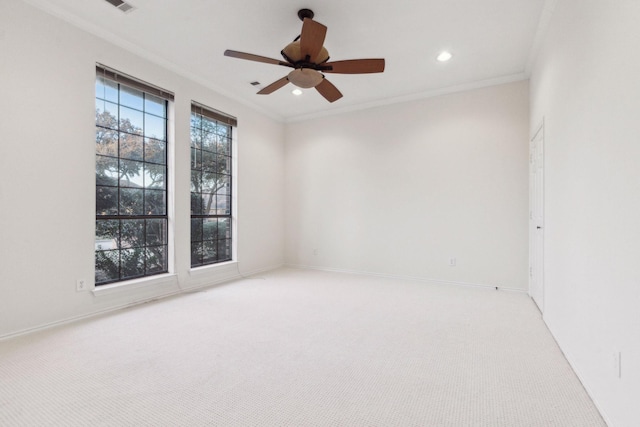 unfurnished room with ornamental molding, ceiling fan, and light carpet