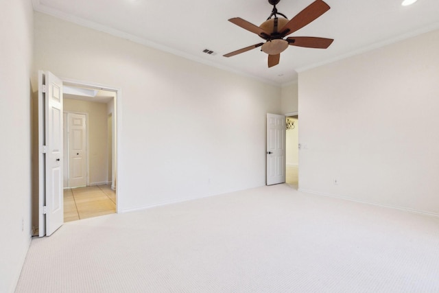 carpeted empty room featuring ceiling fan and ornamental molding