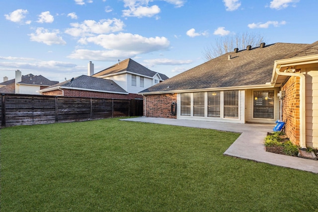 rear view of house featuring a patio and a lawn