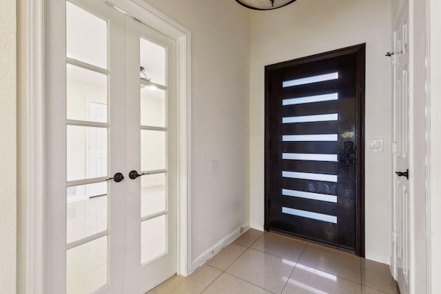 entryway with french doors, light tile patterned floors, and a wealth of natural light