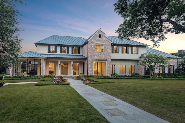 view of front of home with a lawn and a porch