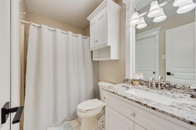 bathroom with toilet, tile patterned flooring, curtained shower, and vanity