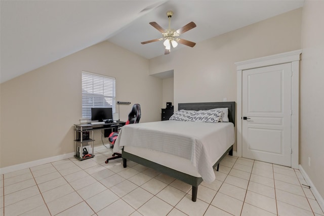 tiled bedroom with lofted ceiling and ceiling fan