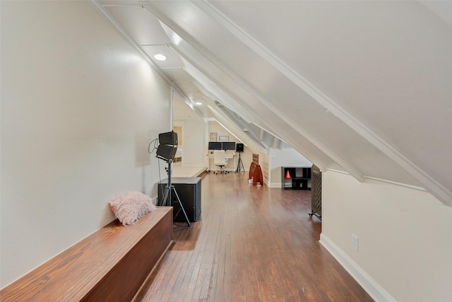 bonus room with hardwood / wood-style flooring and vaulted ceiling