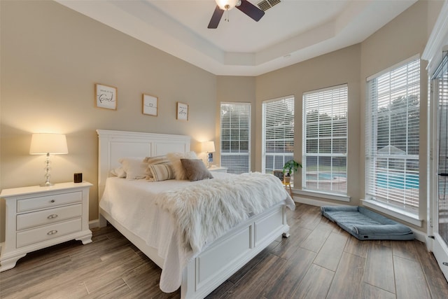 bedroom featuring ceiling fan and a tray ceiling