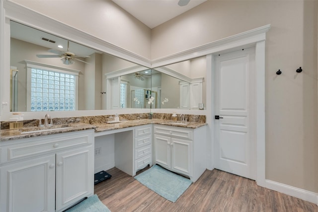 bathroom with an enclosed shower, vanity, hardwood / wood-style floors, and ceiling fan