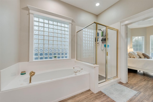 bathroom featuring independent shower and bath and hardwood / wood-style flooring