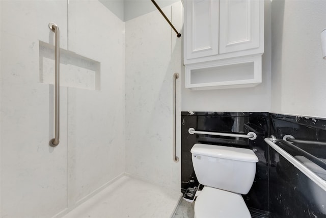 bathroom featuring a shower and toilet