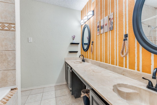 bathroom featuring a textured ceiling, tile patterned flooring, and vanity