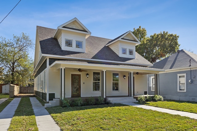 view of front of property with a front yard, ceiling fan, and a porch