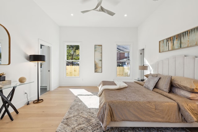 bedroom with ceiling fan and light hardwood / wood-style flooring