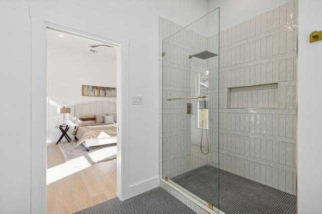 bathroom featuring hardwood / wood-style floors and walk in shower