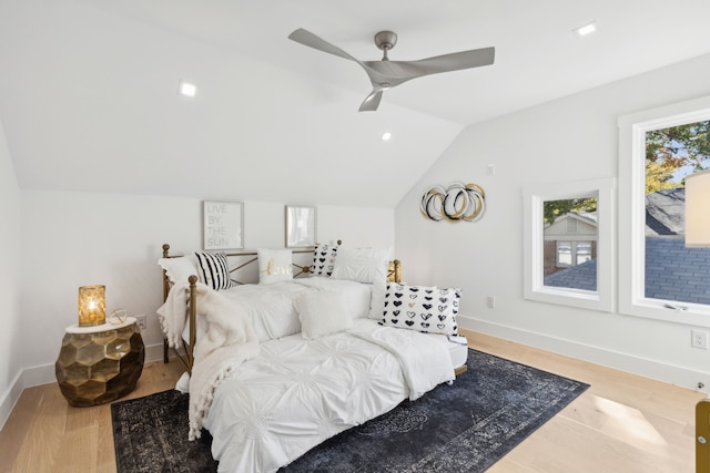 bedroom with ceiling fan, lofted ceiling, and hardwood / wood-style floors