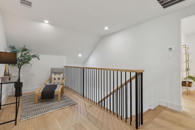 sitting room featuring wood-type flooring and lofted ceiling