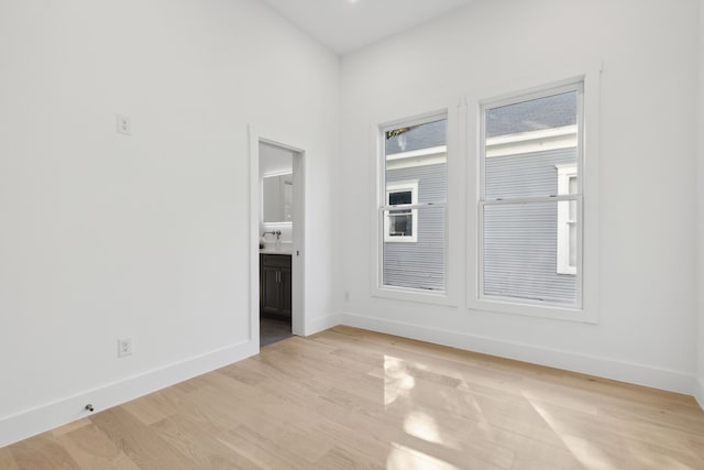 spare room with light wood-type flooring and sink