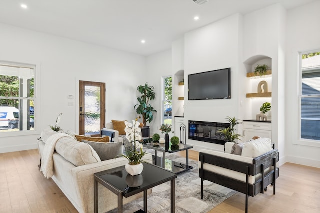 living room with light wood-type flooring and a healthy amount of sunlight