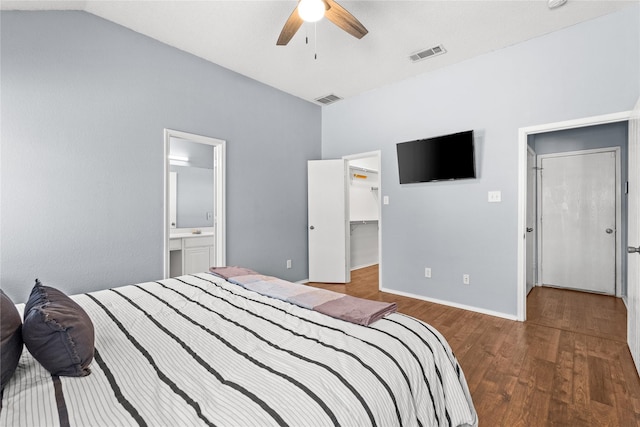 bedroom with hardwood / wood-style floors, connected bathroom, a closet, ceiling fan, and a spacious closet