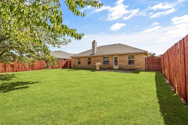 back of property featuring a lawn