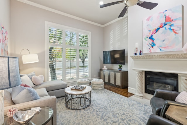 living room featuring ornamental molding, ceiling fan, and hardwood / wood-style floors