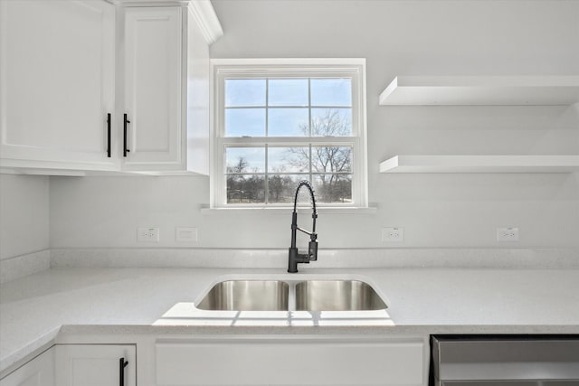 kitchen featuring dishwasher, white cabinets, and sink