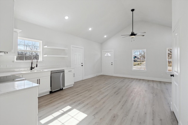 kitchen with white cabinets, dishwasher, sink, ceiling fan, and light hardwood / wood-style flooring